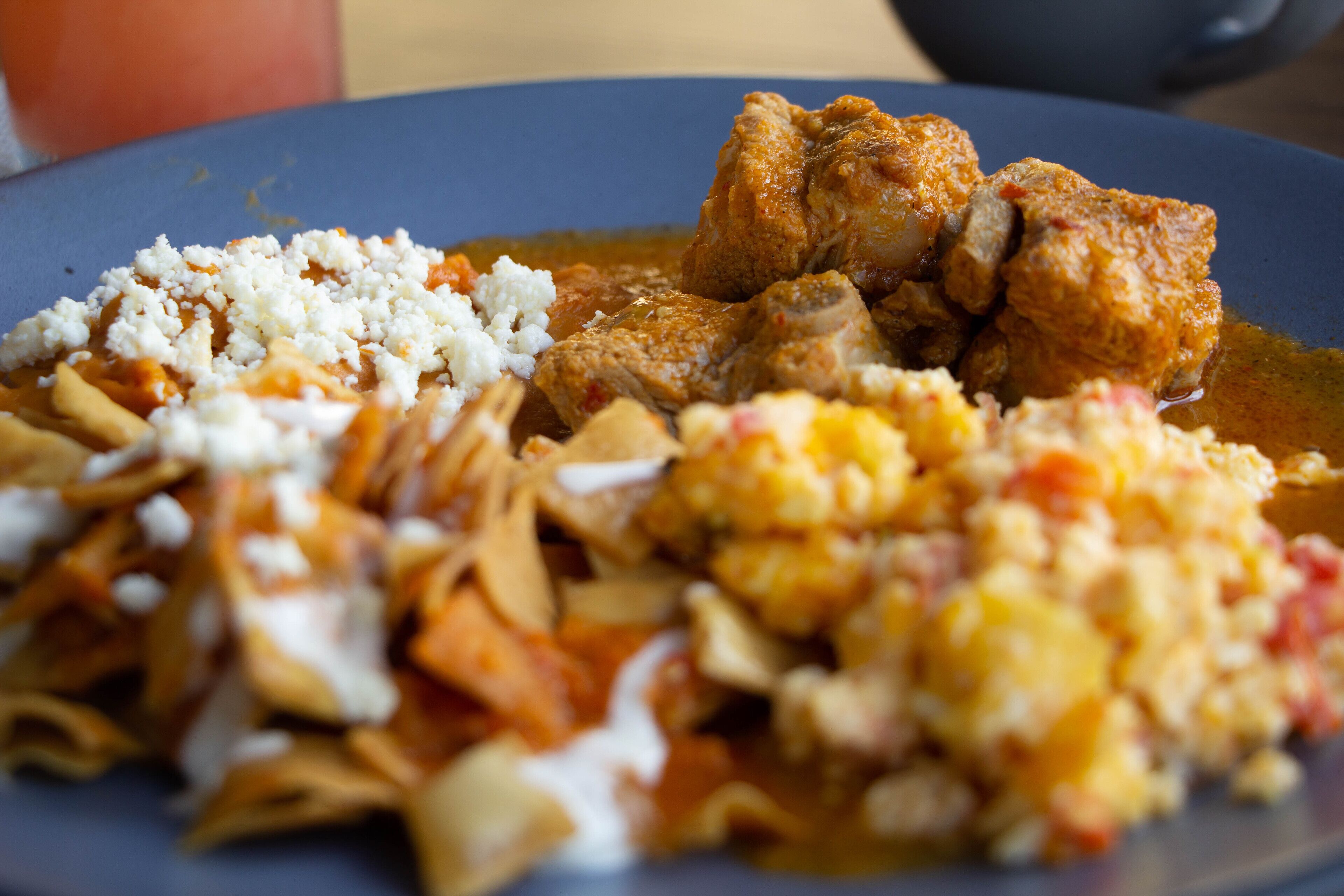 A plate of food with various dishes including a main meat dish, a side of rice, and a vegetable side.