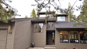 A modern two-story house with a brick driveway and a number '12' on the door. - Cozy Cabin Stay with Access to Exclusive Golf (Sunriver)