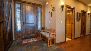 Enter a warm and inviting space with a traditional wooden door and comfortable seating area.