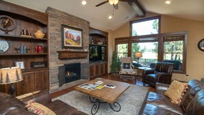 A cozy living room with a fireplace, a television, and comfortable seating. - Luxury Caldera Retreat with Access to Forest House (Bend)