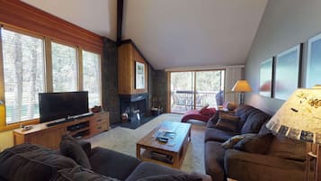 A cozy living room with a fireplace, a television, and a comfortable seating area.