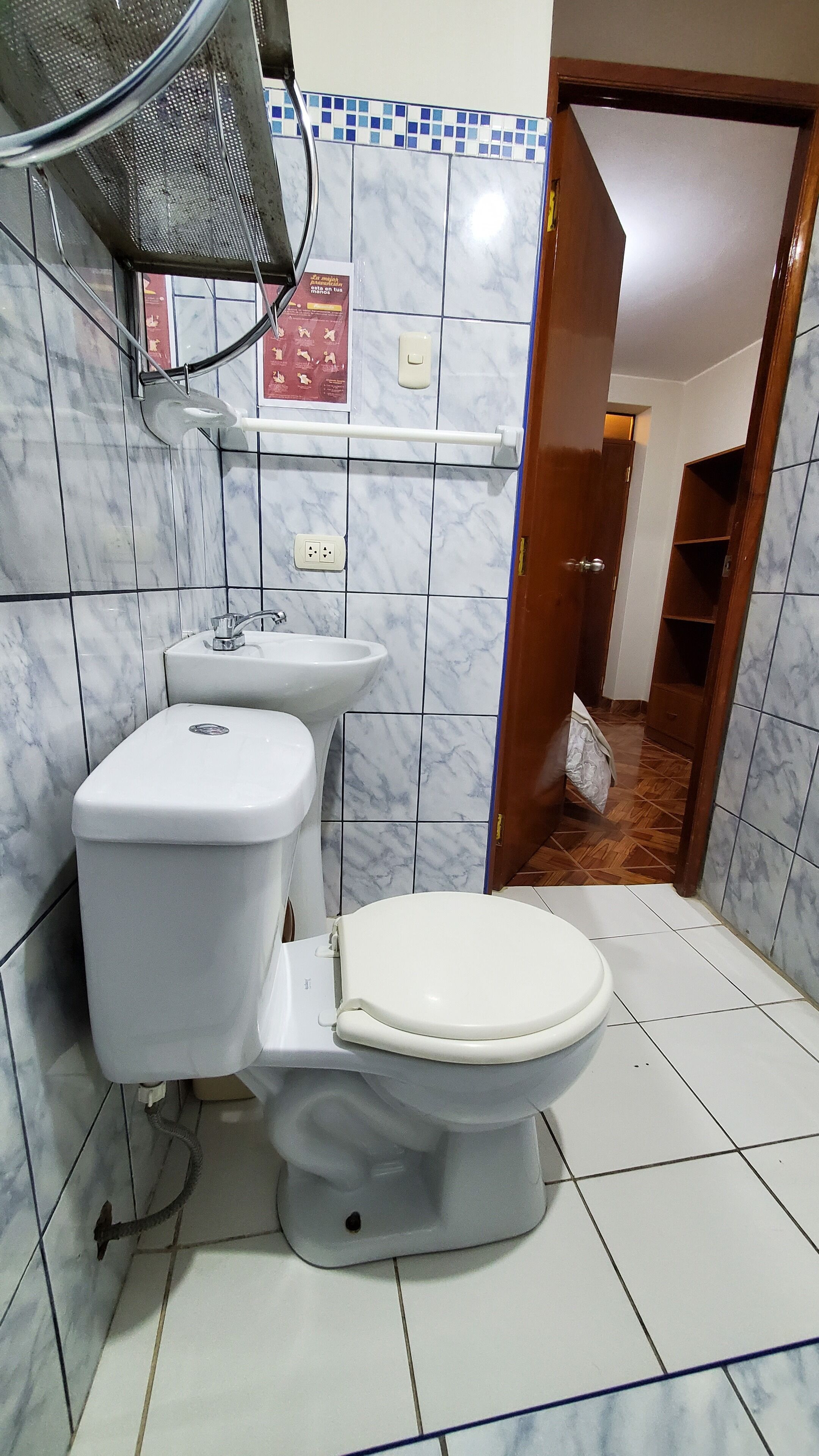 A bathroom with a toilet, bidet, and a shower area.