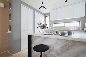 Enjoy cooking in this well-lit kitchen with an oven and microwave, sink, and ample counter space.