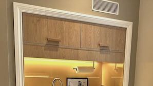 A compact kitchen with a built-in microwave, a sink, and a coffee machine. - The Suites- St Pancras Hotel Group (London)