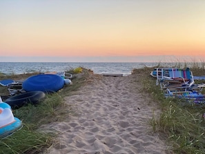 A sandy beach path leading to the sea with beach chairs and umbrellas on the right. - Beach View Cottage - Beautiful View of the Lake! (Holland)
