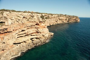 A coastal cliff with a clear view of the sea.