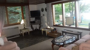 A living room with a television, a table, and two sofas. - WATERSEDGE  GREAT VIEWS (Jefferson)