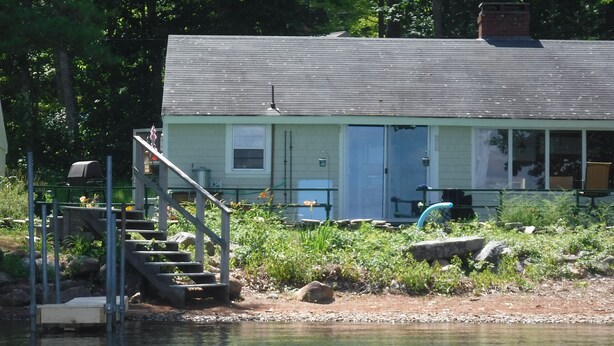 A lakeside cabin with a dock, a staircase leading to the dock, and a small outdoor seating area. - WATERSEDGE  GREAT VIEWS (Jefferson)