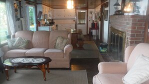 A cozy living room with a sofa, a small table, and a fireplace. - WATERSEDGE  GREAT VIEWS (Jefferson)