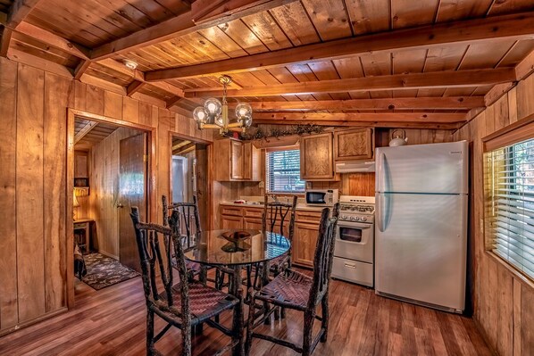 Enjoy cooking in this kitchen with a round table, stainless steel appliances, and a gas stove.