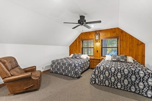 A bedroom with two beds, a ceiling fan, wooden walls, and a window with blinds. - Total Privacy, Plus fun: Hot tub, pool table (Rockbridge)