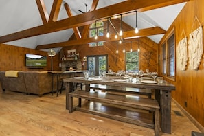 A spacious kitchen with a large island, wooden beams, and a stone fireplace. - Total Privacy, Plus fun: Hot tub, pool table (Rockbridge)