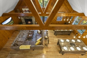 A cozy interior with a fireplace, a sofa, and a dining table. - Total Privacy, Plus fun: Hot tub, pool table (Rockbridge)