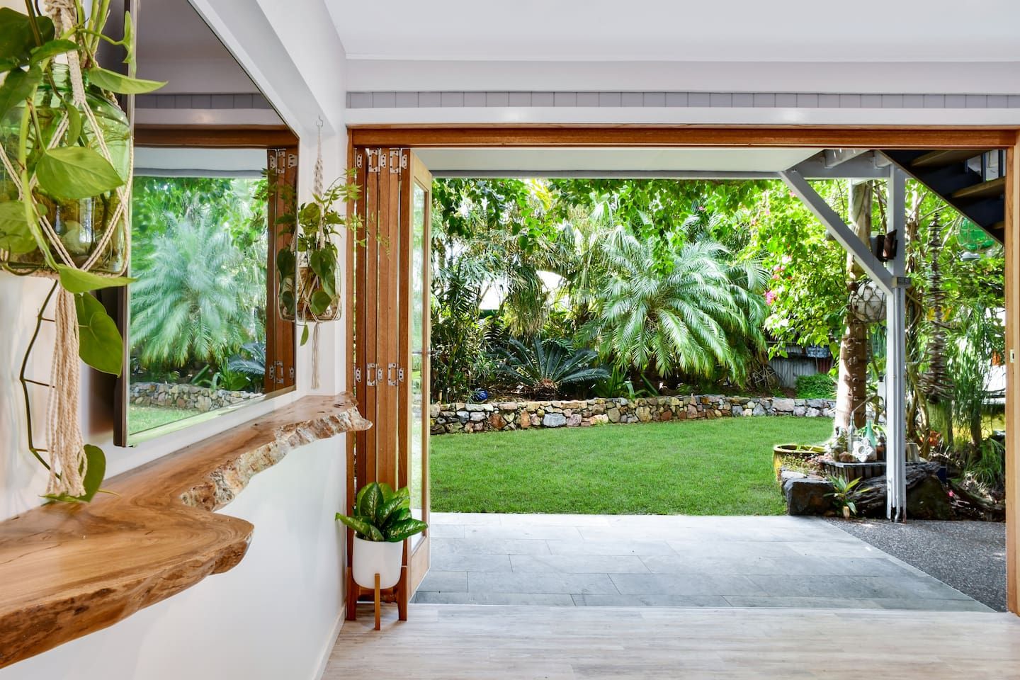 A modern interior with a view of a well-maintained garden.