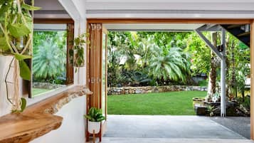 A modern interior with a view of a well-maintained garden.