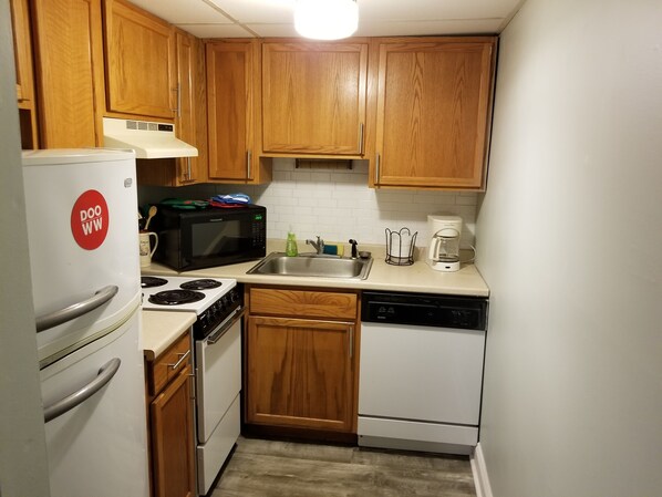Enjoy cooking in this well-equipped kitchen with a stove, refrigerator, microwave, dishwasher, and coffee maker.