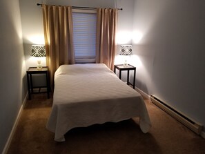 Cozy retreat with a single bed, two bedside tables, and a radiator for comfort.