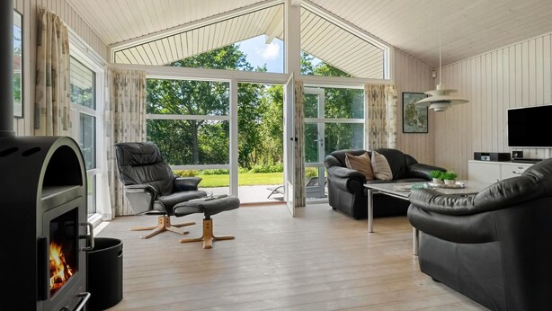 A spacious living room with a fireplace, leather sofas, and a television. - Awesome home in Haderslev with kitchen (Haderslev)