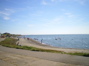 A coastal road with a beach and ocean.