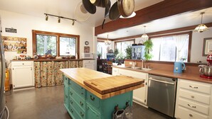 A kitchen with a central island, wooden cabinets, a dishwasher, and a window with curtains. - PERFECT FAMILY GETAWAY! Historic CRYSTAL SPRINGS INN is all yours - 4,000 sq ft! (ALTA)