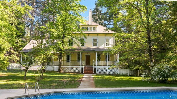 A two-story house with a front porch, a swimming pool, and a white picket fence. - PERFECT FAMILY GETAWAY! Historic CRYSTAL SPRINGS INN is all yours - 4,000 sq ft! (ALTA)