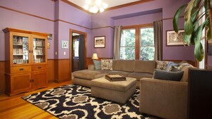 A living room with a sectional sofa, a wooden cabinet, and a patterned rug. - PERFECT FAMILY GETAWAY! Historic CRYSTAL SPRINGS INN is all yours - 4,000 sq ft! (ALTA)