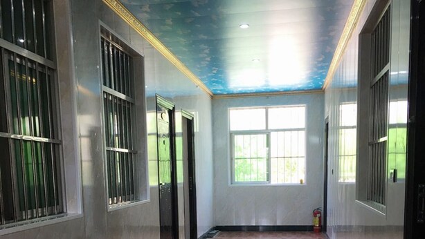 A spacious hallway with wooden flooring, large windows, and a ceiling painted with a sky and clouds design. - Huayang Guesthouse (Xianyang)