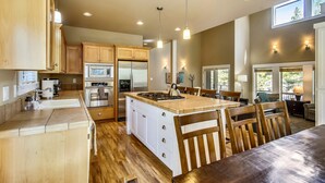 A spacious kitchen with wooden cabinets, stainless steel appliances, and a central island.