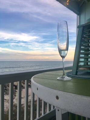 A glass of water on a table with a view of the ocean. - Our BIG BEAUTIFUL BEACH is back Amazing Oceanfront Condo w/ Breathtaking VIEWS (Carolina Beach)