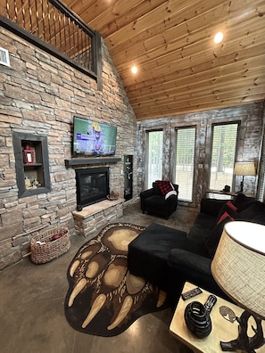 Relax in this inviting living room with a fireplace, flat-screen TV, and comfortable sofa.
