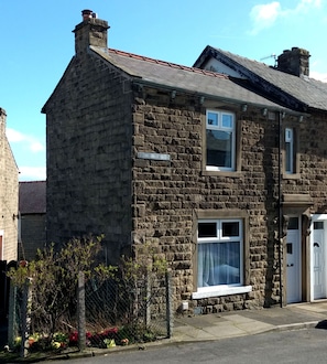 Classic home with a traditional pitched roof and small front garden.