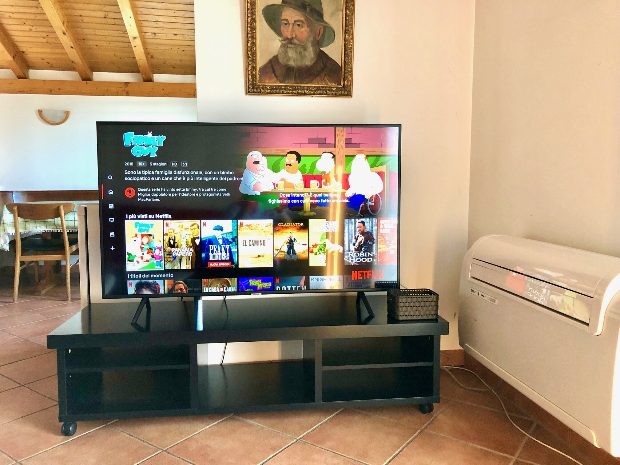 A television displaying a Netflix interface with various shows and movies.