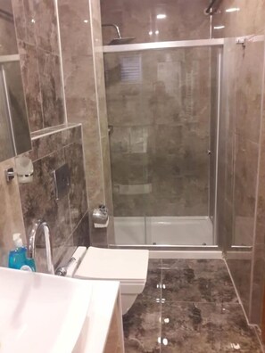 Shower, rainfall showerhead, slippers, towels