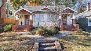 A two-story house with a front porch, a brick chimney, and a number '403' on the front wall. - Chic Craftsman, Walk Downtown (Durham)