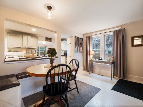 Enjoy cooking in this well-equipped kitchen with a central island, stove, coffee maker, and ample dining space.
