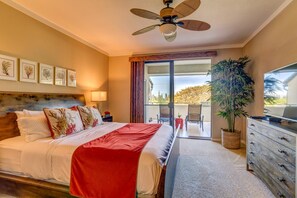 A hotel room with a bed, a ceiling fan, a TV, a dresser, and a balcony with a view. - Kapalua Golf Villas | Ocean View 1 BR | Car Incl. w/ 6+ Nights | KGV-16T4 by KBM (Lahaina)