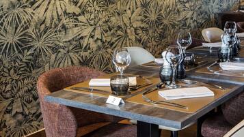 A dining table set with wine glasses, cutlery, and a number tag.