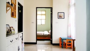 A room with a bed, a desk, a chair, a wardrobe, and a window. - Happy Tree Hostel (Jinning)