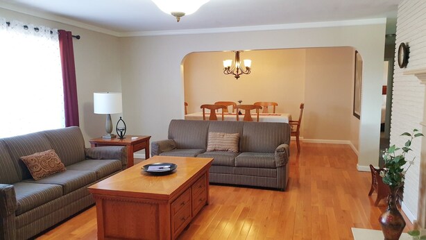 A living room with a sofa, a coffee table, and a dining area with a table and chairs. - West Yakima - Clean - Safe - Netflix - 4212 - ONWU-LLC (Yakima)