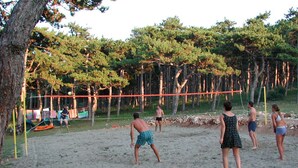 A sandy volleyball court surrounded by trees. - Kamp Planik- Campsite (Razanac)
