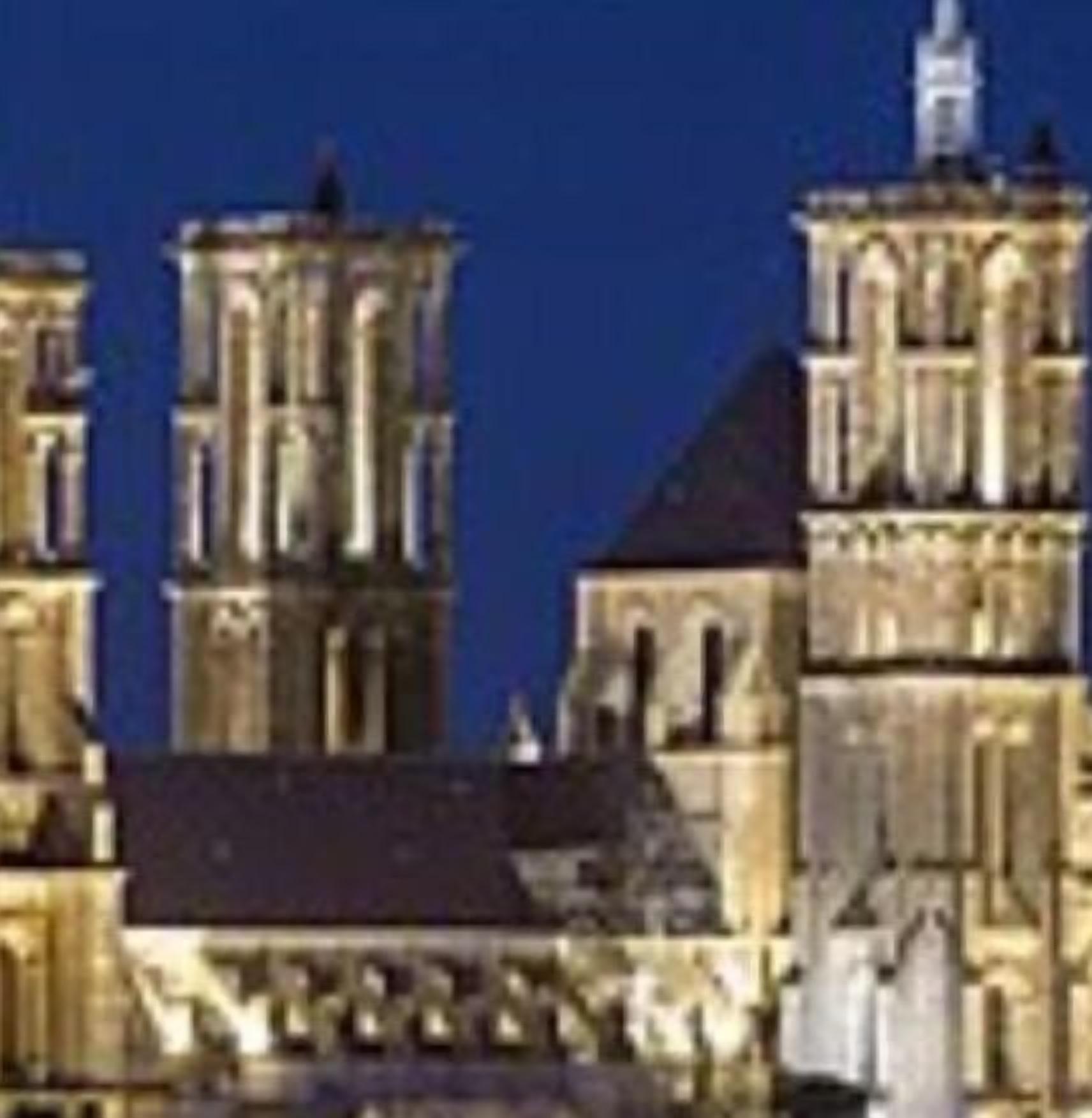 A historic building with multiple towers and a prominent central spire.