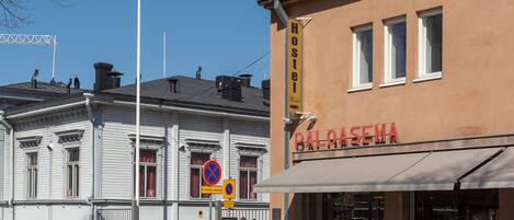 A hostel with a sign reading "Hostel" and a building with a sign "BALOASEMA".