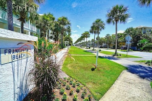A street view of a residential area with a sign reading "FRANCE BEACH".