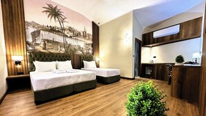 A hotel room with two beds, a mural on the wall, a small kitchenette, and a wooden ceiling. - Aqua Marin Spa&Wellness (Altinova)