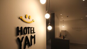 A hotel reception area with a sign reading "HOTEL YAM" and a smiley face above the text. - Busan Haeundae Hotel A (Busan)