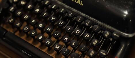 A black typewriter with the brand name "Continental" visible on the front.