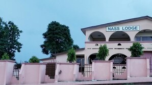 A building with a sign reading "NASS LODGE". - Nass Lodge (Sunyani)