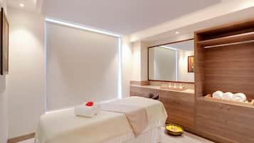 Enjoy a restful stay in this stylish room with a neatly made bed, large mirror, and convenient storage.