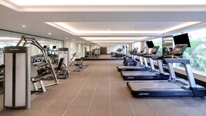 A modern gym with treadmills, weight machines, and exercise bikes. - Lemon Tree Premier Mumbai Intl. Airport (Mumbai)