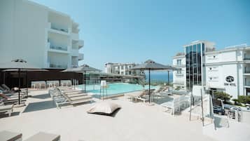 Seasonal outdoor pool, pool umbrellas, pool loungers